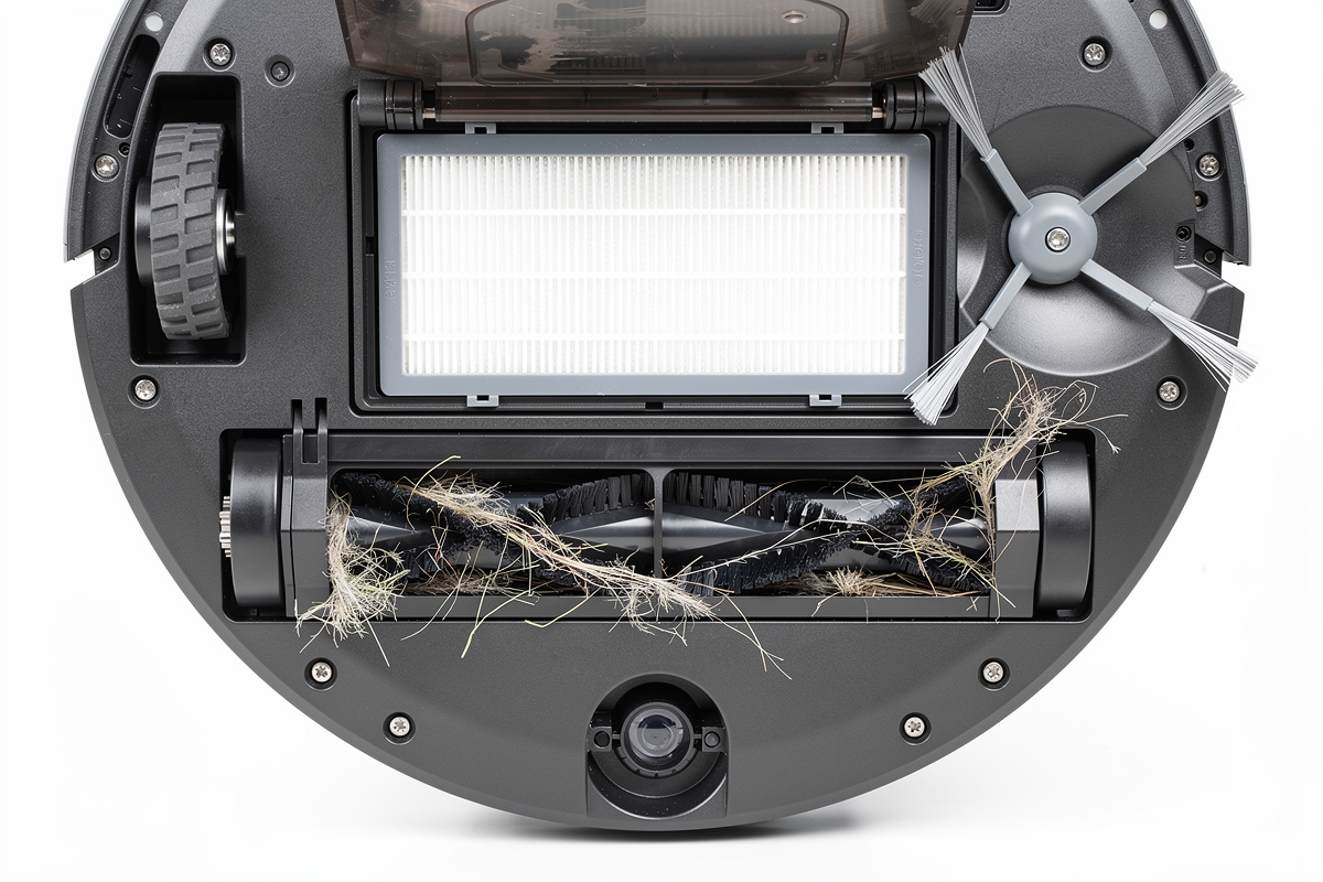 Robot vacuum underside showing dual rubber brush extractors side brush and open dustbin with HEPA filter