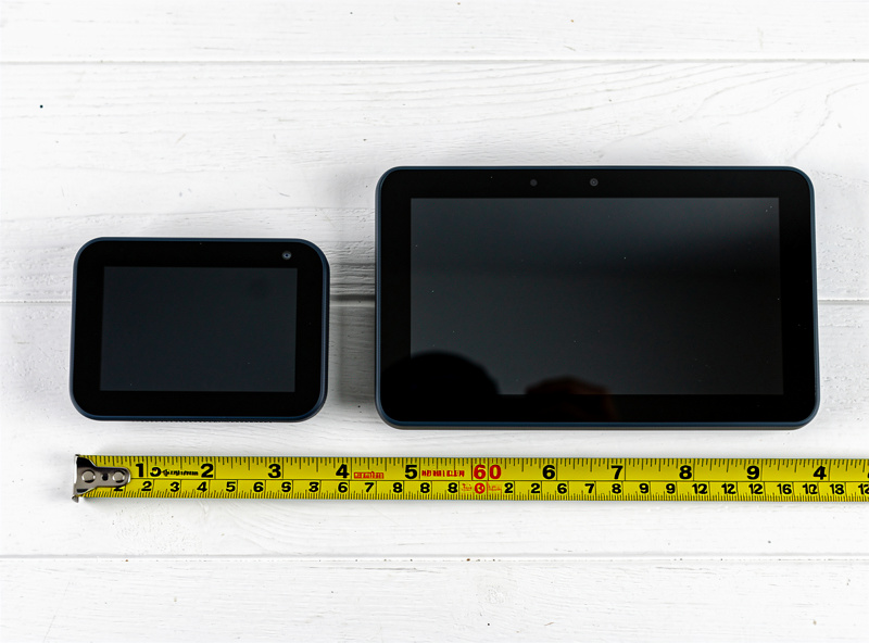 Echo Show 5 next to Echo Show 8 on a wooden table showing relative size difference