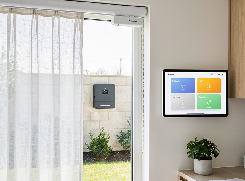 Smart home accessories lineup showing energy monitor, tablet wall mount, pet feeder, and sprinkler controller on display table