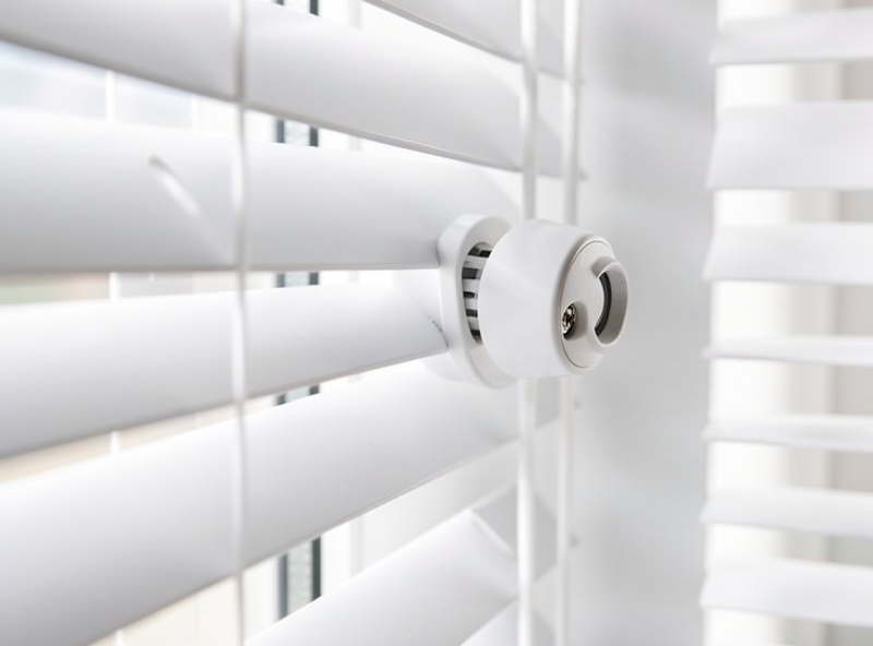 Close-up of a clip-on tilt motor driving the slats of a venetian blind