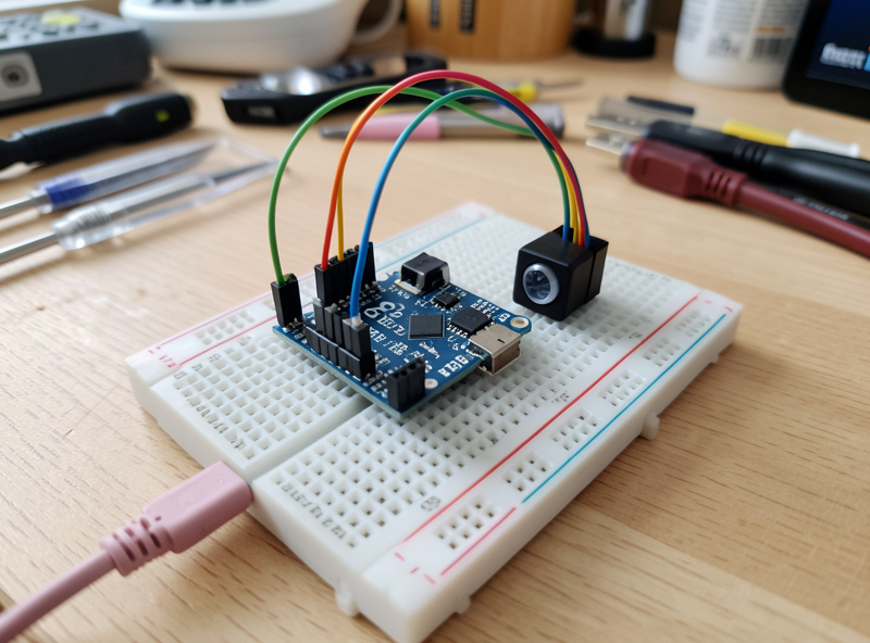 ESP32 board wired on a breadboard with temperature and motion sensor modules