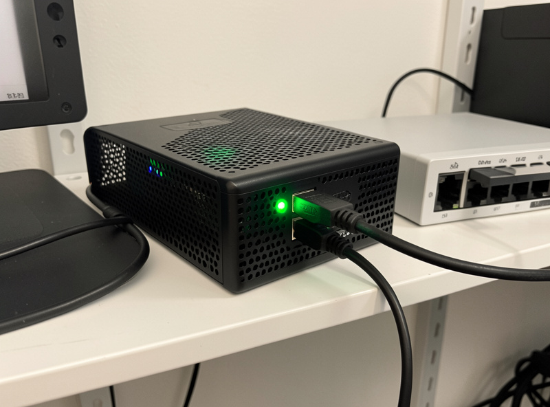 Raspberry Pi in a vented case with SSD running as a local home automation hub next to a network switch