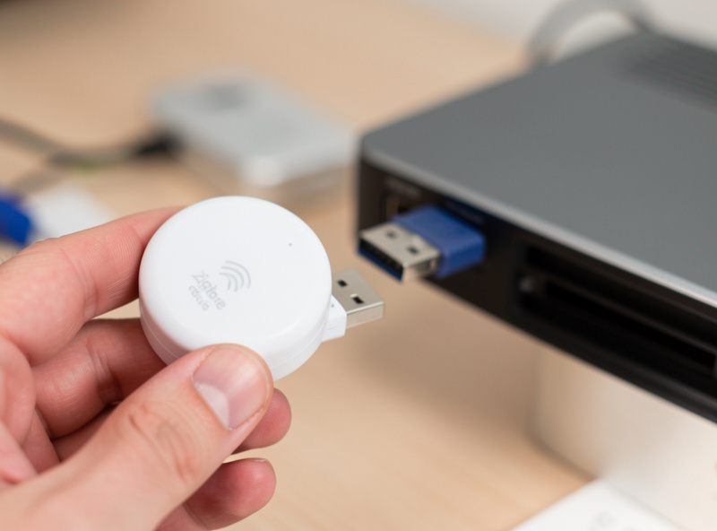 A smart sensor held close to a smart home hub during the pairing process