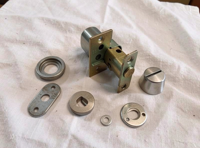 The interior anatomy of a deadbolt with the thumb-turn removed, parts laid out