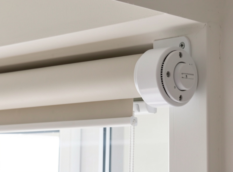 Motorized roller shade tube with a tubular drive motor visible at the end