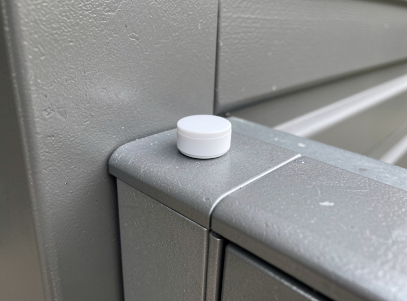 Zigbee tilt sensor mounted on the top panel of a sectional garage door