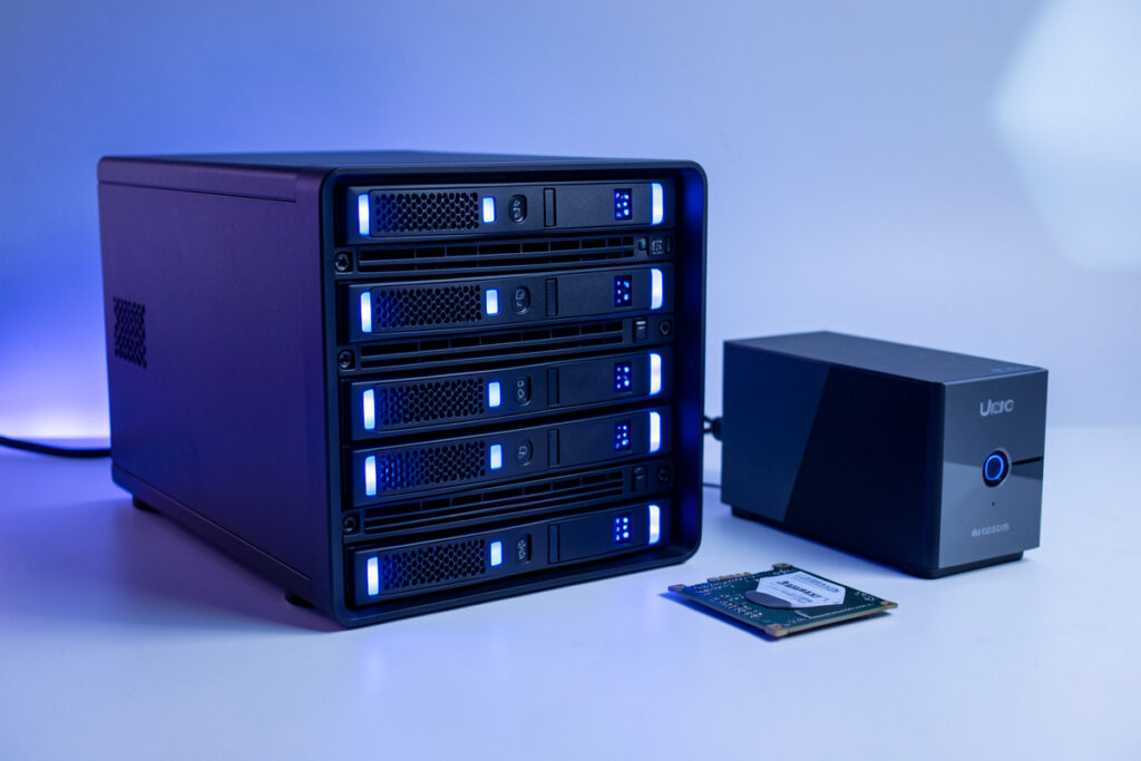Home NAS unit with several hard drives and an SSD beside a mini-PC